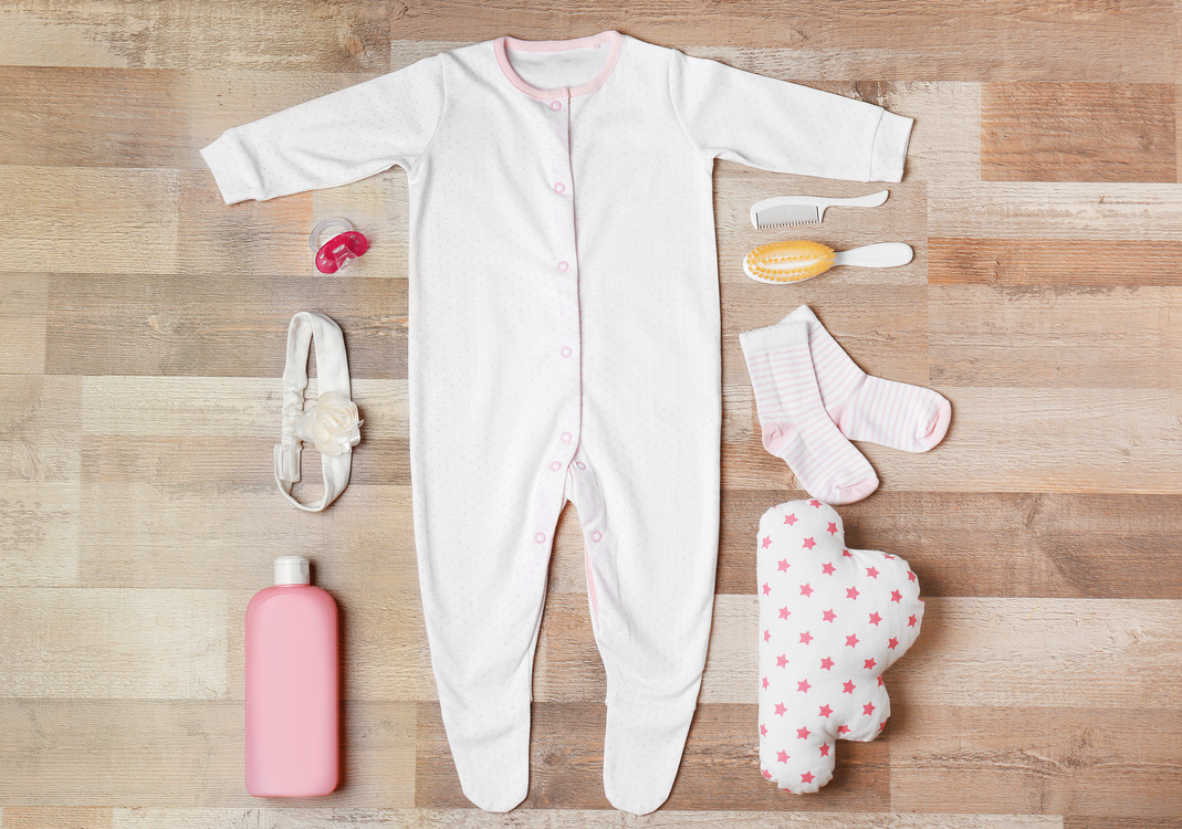 Baby Clothes and Accessories on Wooden Background